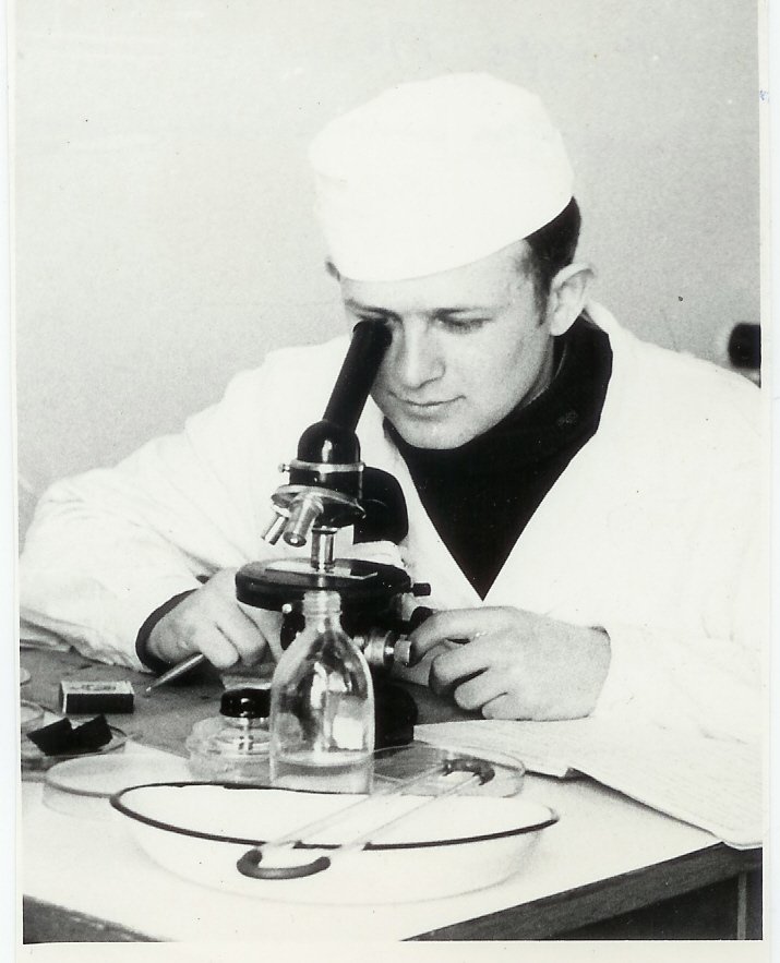 Historical photograph of Dr. Kolchansky studying with a microscope